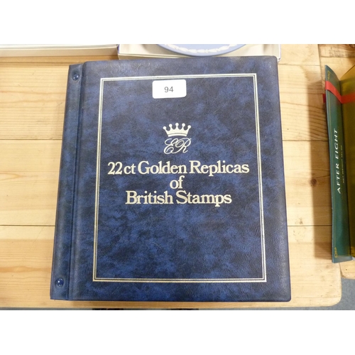 94 - Folder containing 22ct golden replicas of British stamps.