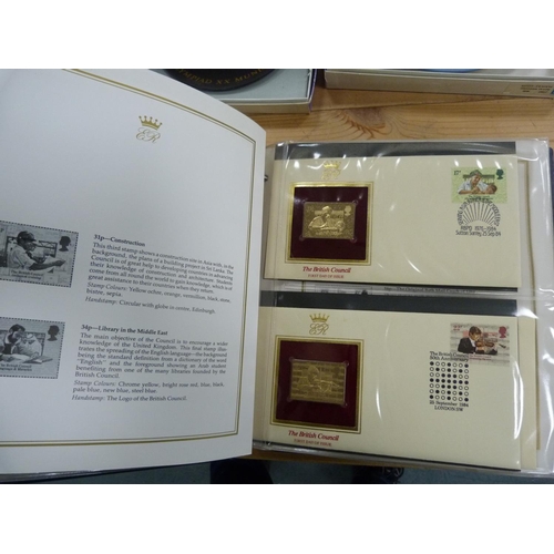 96 - Folder containing 22ct golden replicas of British stamps.