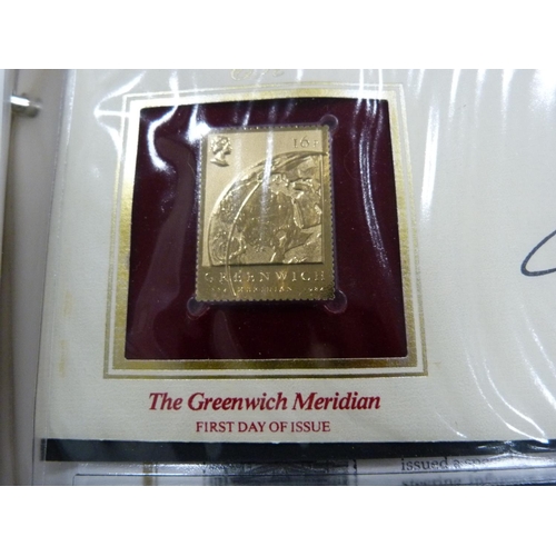 96 - Folder containing 22ct golden replicas of British stamps.