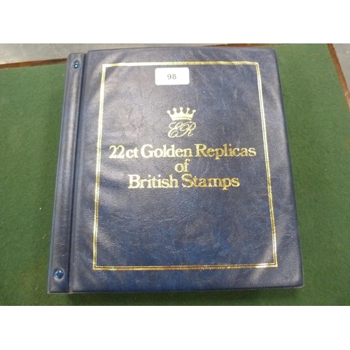 98 - Folder containing 22ct golden replicas of British stamps.