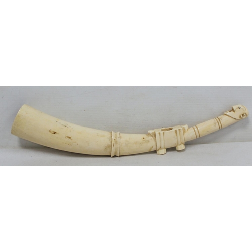 336 - Late 19th/early 20th century African carved ivory pipe with mask terminal and ribbing to body, 45cm ... 