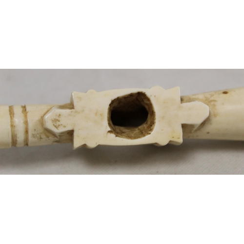 336 - Late 19th/early 20th century African carved ivory pipe with mask terminal and ribbing to body, 45cm ... 