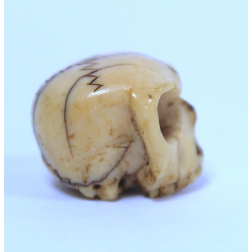 338 - 19th century carved ivory Momento Mori skull, approx. 2.5cm long.  NB: Bidders are responsible ... 