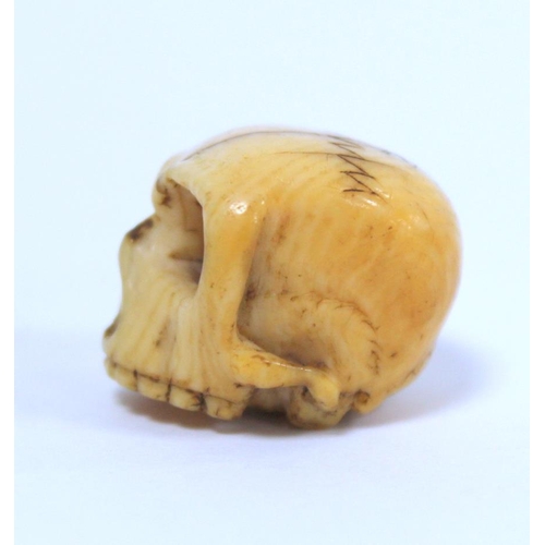 338 - 19th century carved ivory Momento Mori skull, approx. 2.5cm long.  NB: Bidders are responsible ... 