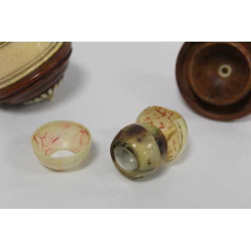 339 - Turned ivory and coquilla nut box of cylindrical form containing a model of an eyeball with removeab... 