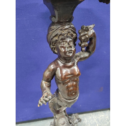 552 - Italian style carved wood torchere, modelled as a semi-clad putti holding grapes, on carved scroll t... 