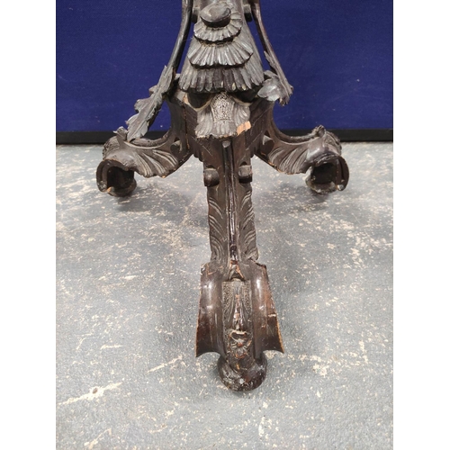 552 - Italian style carved wood torchere, modelled as a semi-clad putti holding grapes, on carved scroll t... 