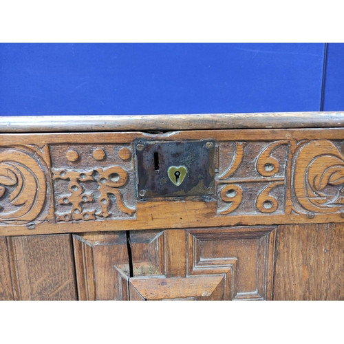 557 - William & Mary oak coffer, with a carved panelled front, bearing inscription ER and dated 1696, ... 