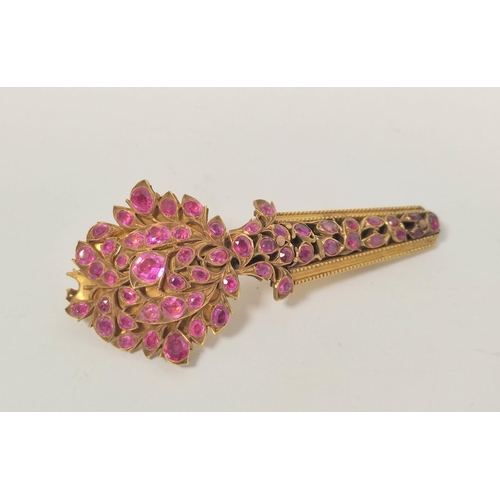 23 - Indian 19th century yellow gold turban pin, pave set with sprays of rubies, now 7.4cm, 23g gross.