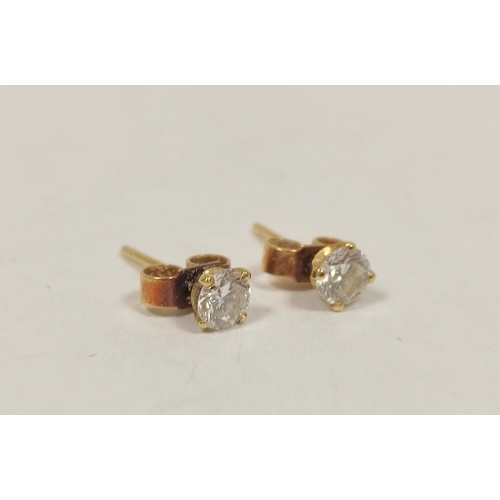 57 - Pair of diamond earrings, each a brilliant approx .25ct in gold.