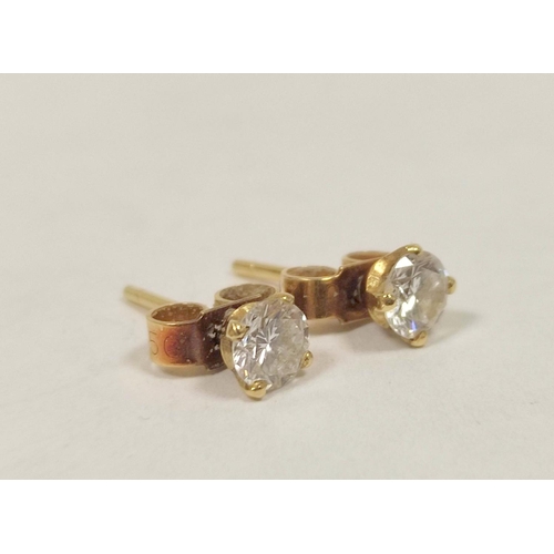 57 - Pair of diamond earrings, each a brilliant approx .25ct in gold.