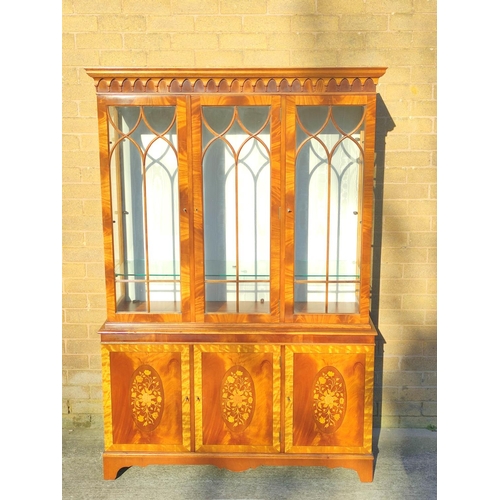 565 - Reproduction mahogany display cabinet with three astragal glazed doors above a lower cupboard crossb... 