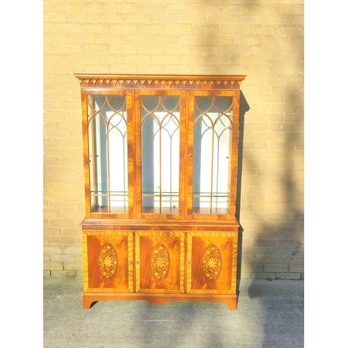 565 - Reproduction mahogany display cabinet with three astragal glazed doors above a lower cupboard crossb... 