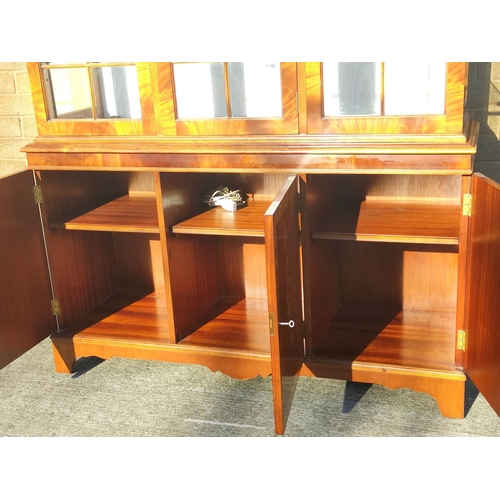 565 - Reproduction mahogany display cabinet with three astragal glazed doors above a lower cupboard crossb... 