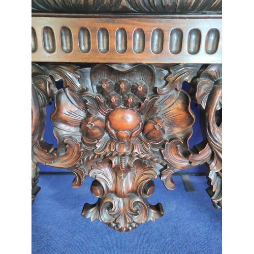 562 - Impressive walnut console table base on scroll supports profusely carved with grotesque birds at eac... 