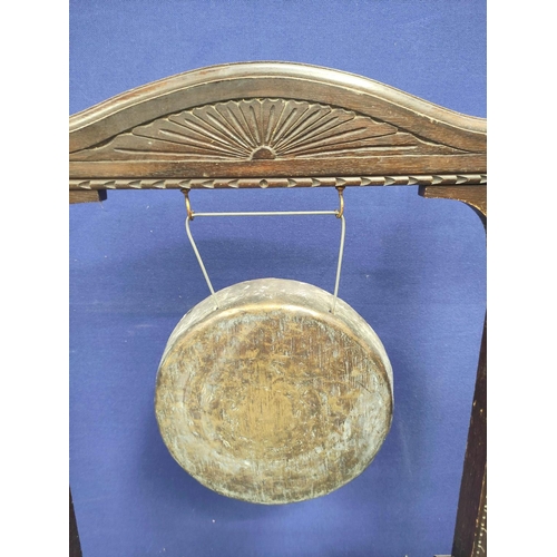 568 - Antique 1920s service gong with a ark oak frame carved with oriental motifs. Complete with beater. 1... 