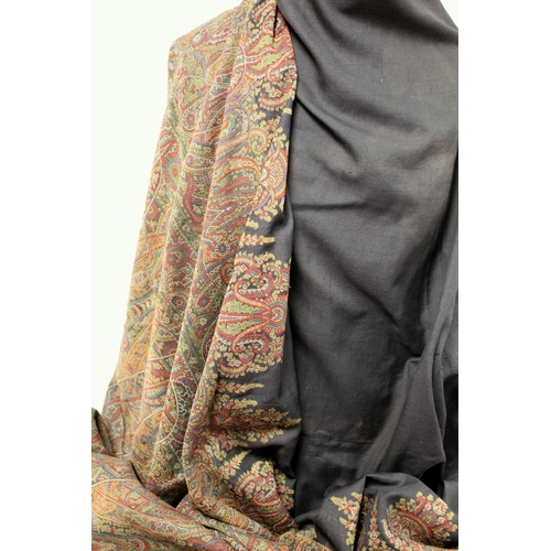 412 - Large Victorian paisley wool shawl, the black field with woven polychrome borders of boteh, some dar... 