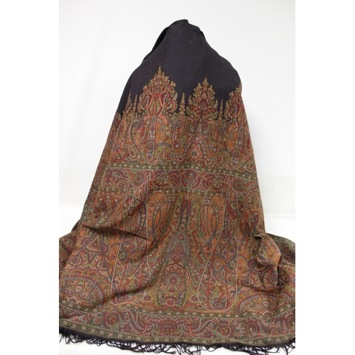 412 - Large Victorian paisley wool shawl, the black field with woven polychrome borders of boteh, some dar... 