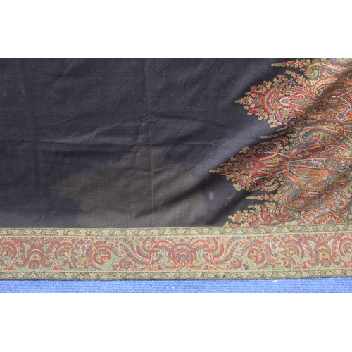 412 - Large Victorian paisley wool shawl, the black field with woven polychrome borders of boteh, some dar... 