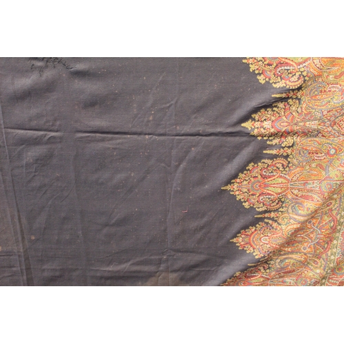 412 - Large Victorian paisley wool shawl, the black field with woven polychrome borders of boteh, some dar... 