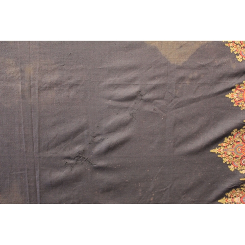 412 - Large Victorian paisley wool shawl, the black field with woven polychrome borders of boteh, some dar... 