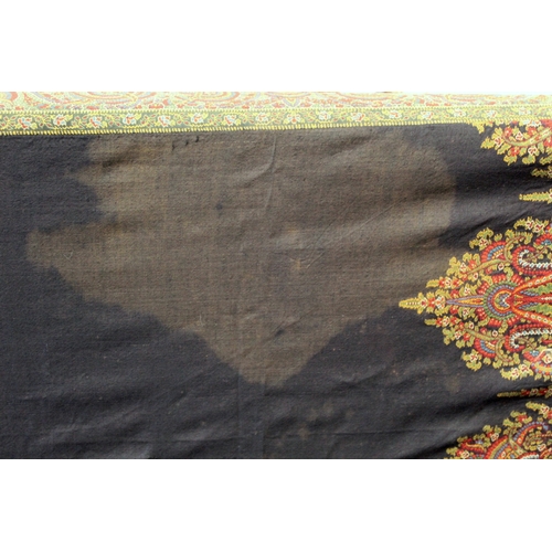 412 - Large Victorian paisley wool shawl, the black field with woven polychrome borders of boteh, some dar... 