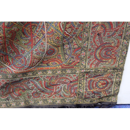 412 - Large Victorian paisley wool shawl, the black field with woven polychrome borders of boteh, some dar... 