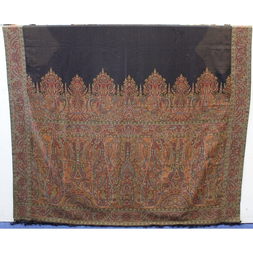 412 - Large Victorian paisley wool shawl, the black field with woven polychrome borders of boteh, some dar... 