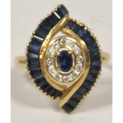 69 - Dress ring with an oval sapphire and diamond cluster and baguette sapphires, in 18ct gold, 198g, siz... 