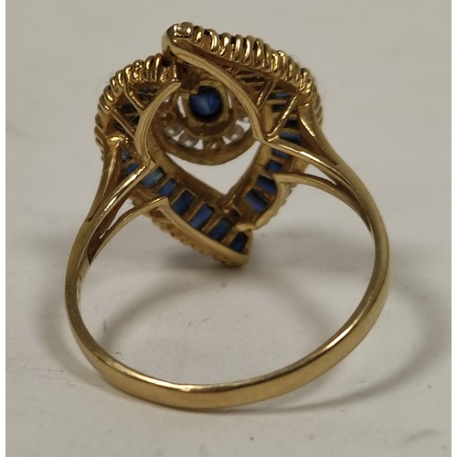 69 - Dress ring with an oval sapphire and diamond cluster and baguette sapphires, in 18ct gold, 198g, siz... 