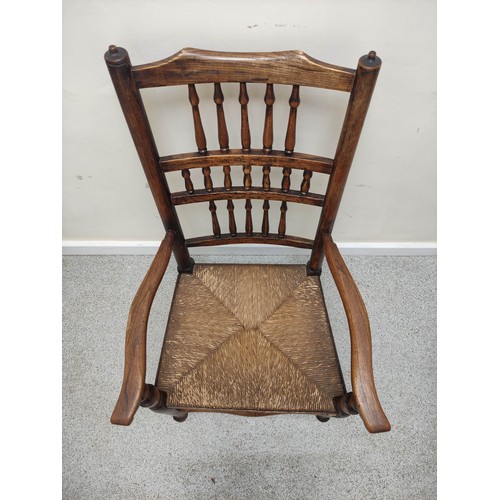 577 - 19th century oak rushwork Lancashire chair, with bobbin turned spindle back supports, raised on pad ... 