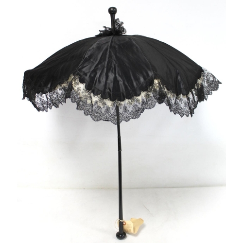 418 - Victorian black satin parasol with lace edging, cream silk lining and ebonised tapered handle and kn... 