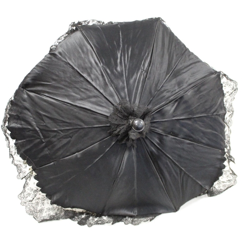 418 - Victorian black satin parasol with lace edging, cream silk lining and ebonised tapered handle and kn... 