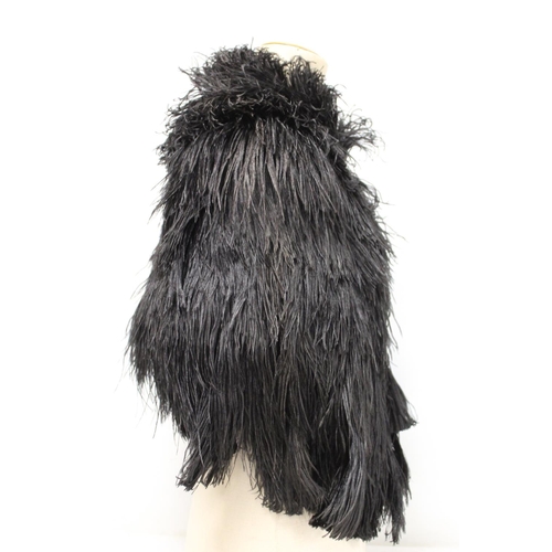 422 - Early 20th century black ostrich feather ladies cape with tasseled cord fastener and black rayon lin... 