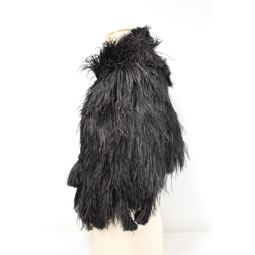 422 - Early 20th century black ostrich feather ladies cape with tasseled cord fastener and black rayon lin... 