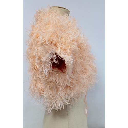 428 - Early 20th century bolero jacket of apricot ostrich feather with satin lining and ribbon tie.