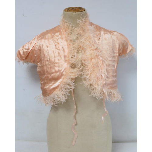 428 - Early 20th century bolero jacket of apricot ostrich feather with satin lining and ribbon tie.