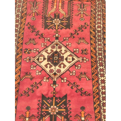 85 - Persian wool rug with central diamond medallion on red field with cream, brown and orange borders, 2... 