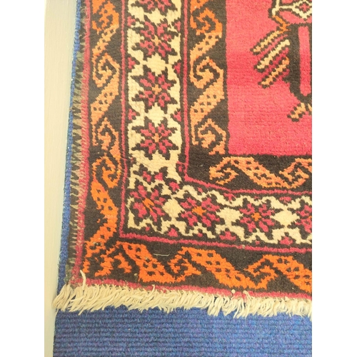 85 - Persian wool rug with central diamond medallion on red field with cream, brown and orange borders, 2... 