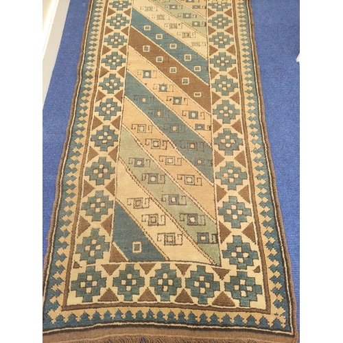 89 - Turkish wool runner with geometric field and borders in blue, brown and cream, 324cm x 82cm.