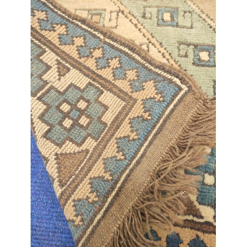 89 - Turkish wool runner with geometric field and borders in blue, brown and cream, 324cm x 82cm.