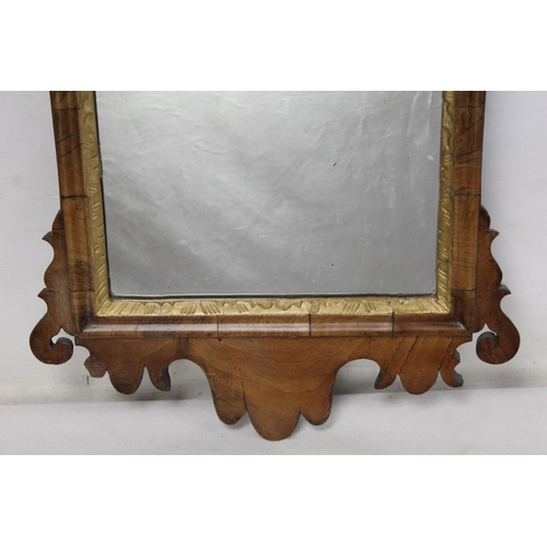 179 - George III style wall mirror with fret cut walnut veneered frame, pierced foliate pediment and mould... 