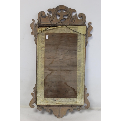 180 - George III style mahogany veneered wall mirror with fret cut frame, pierced bird pediment and bevell... 