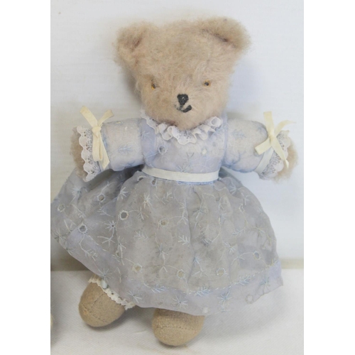 494 - Two early 20th century vintage teddy bears, one miniature in white mohair wearing a blue dress, 19cm... 