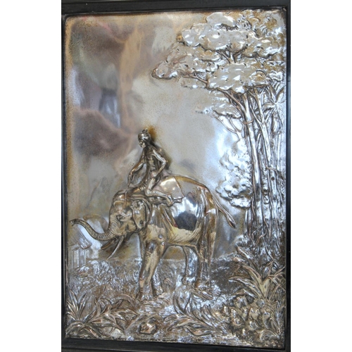 504 - 20th century silvered electrotype wall plaque depicting an elephant and his mahout walking nearing a... 