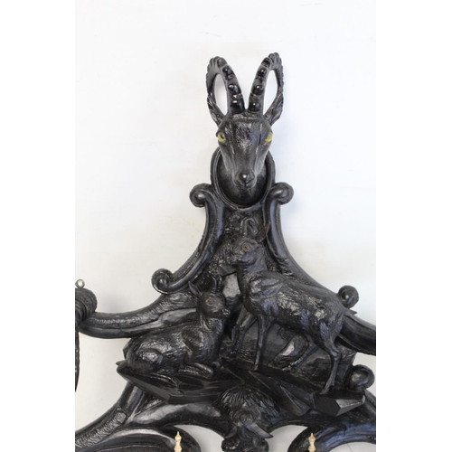 506 - Late 19th/early 20th century Black Forest ebonised carved hat and coat rack, the central panel depic... 