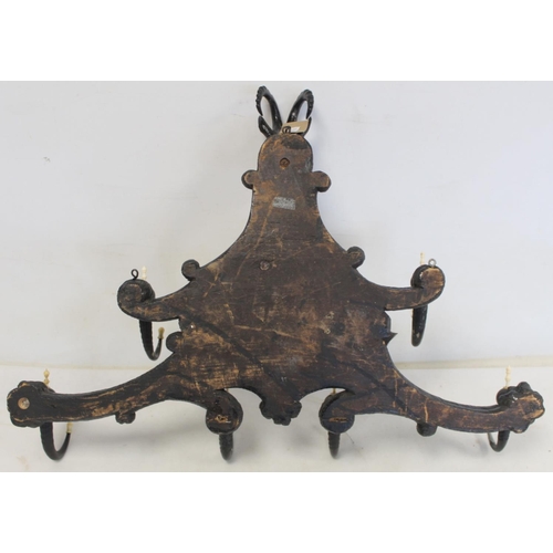 506 - Late 19th/early 20th century Black Forest ebonised carved hat and coat rack, the central panel depic... 