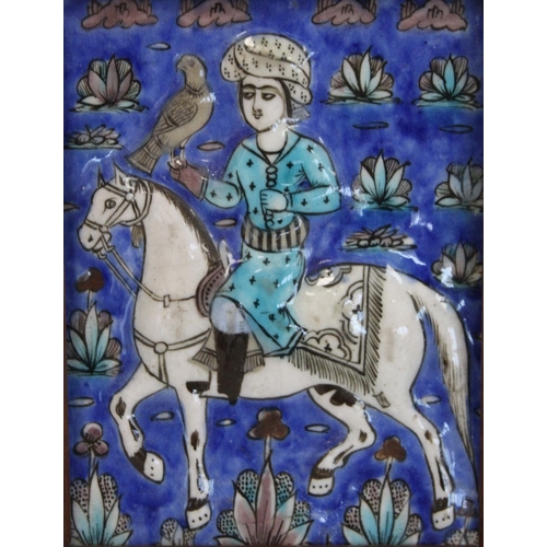 462 - Persian glazed tile or panel decorated in a typical Qajar manner with a figure on horseback hunting ... 