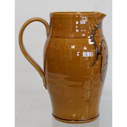 467 - Large studio pottery jug of ovoid form with ochre glaze and tube lined stylised decoration of a dove... 