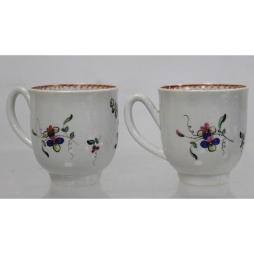 476 - Two 18th century English porcelain coffee cups decorated with polychrome floral sprays and iron red ... 